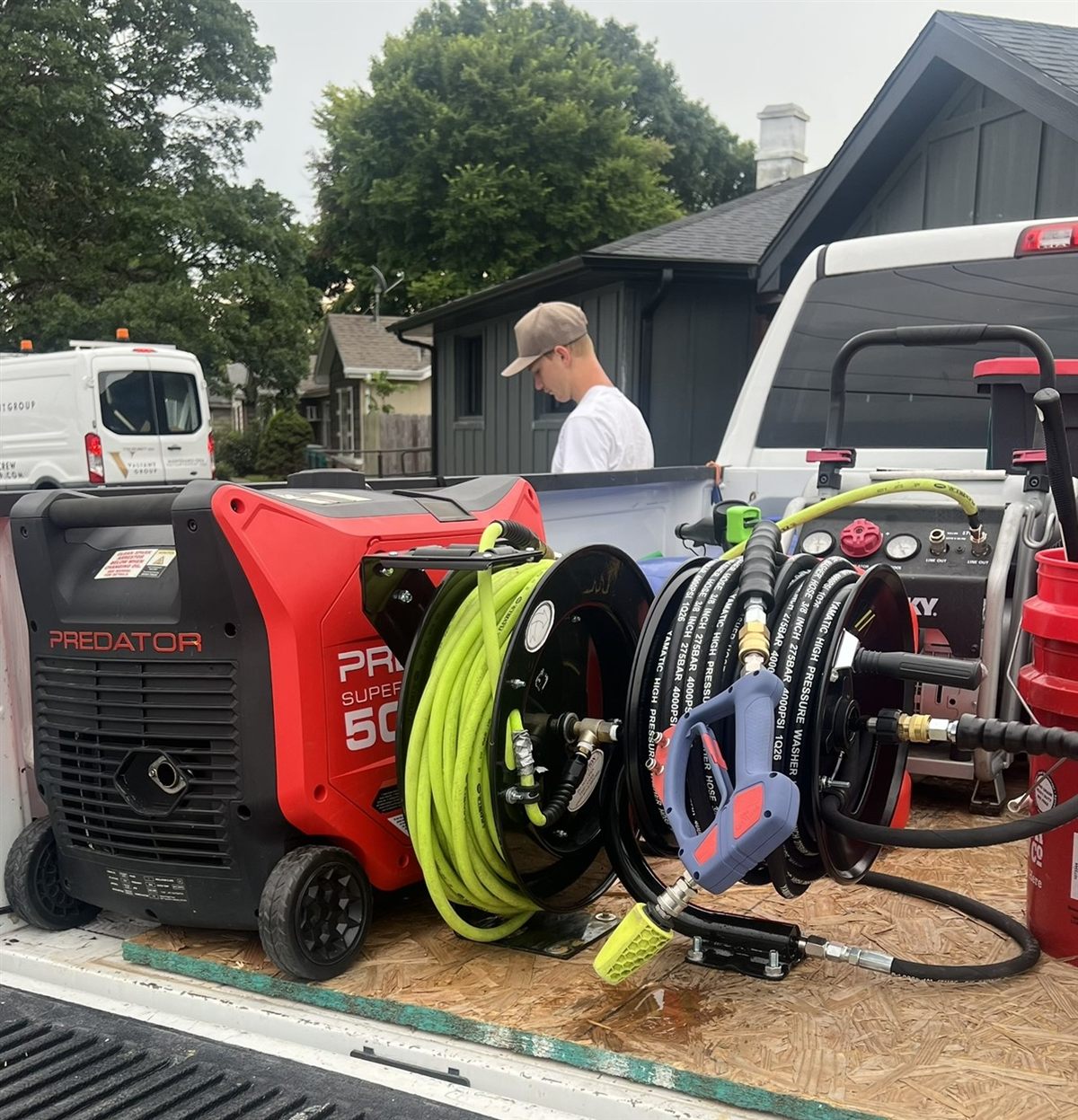 The mobile detailing rig loaded in the truck bed - generator, pressure washer and hose reels